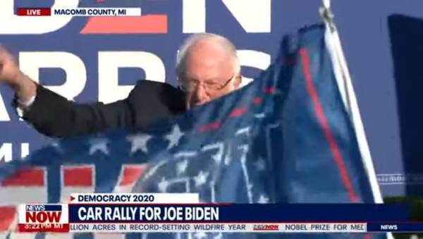  Trump Supporter Disrupts Bernie Sanders at Biden Drive-In Rally; Has Trump 2020 Flag Stolen by Reporter (Video)