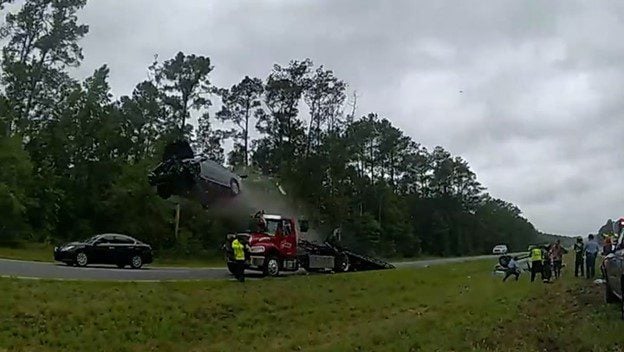  WATCH: Car Sails 120 Feet Over Tow Truck “Dukes of Hazzard-Style” in Wild Highway Crash – Two Severe Injuries Reported